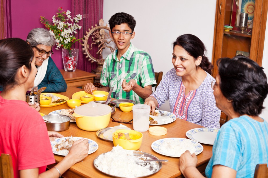 Cheerful Asian Indian Family Enjoying Meal Together